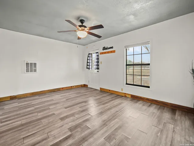 a kitchen with stainless steel appliances a refrigerator sink and white cabinets