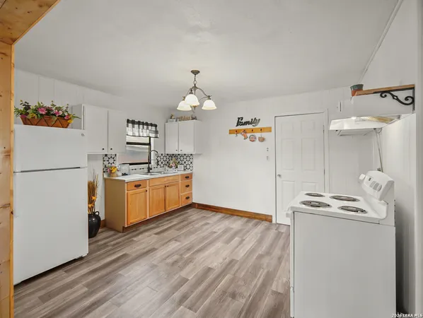 a kitchen with stainless steel appliances a refrigerator sink and stove