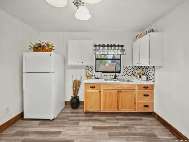 a white toilet sitting next to a white wall