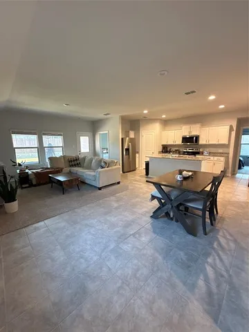 a living room with furniture and a piano