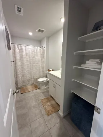 a bathroom with a double vanity sink toilet and shower
