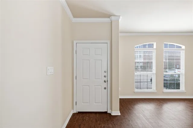 a view of wooden floor and windows in a room