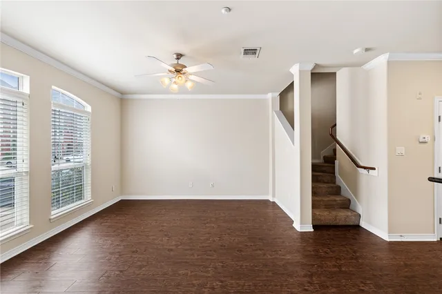 a view of an entryway with wooden floor and a ceiling fan