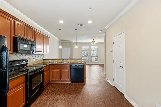 a large kitchen with stainless steel appliances granite countertop a stove and a refrigerator