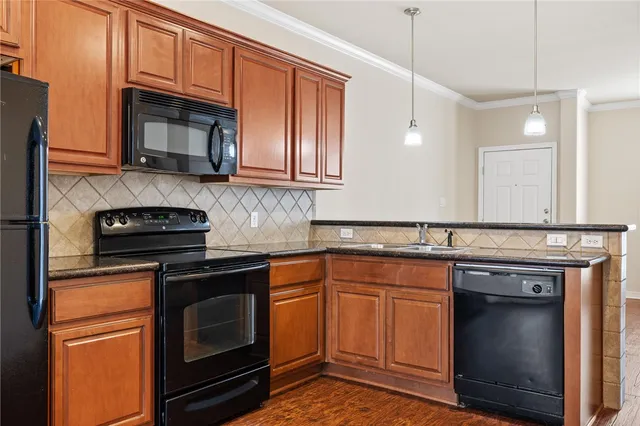 a kitchen with stainless steel appliances granite countertop a stove microwave and cabinets