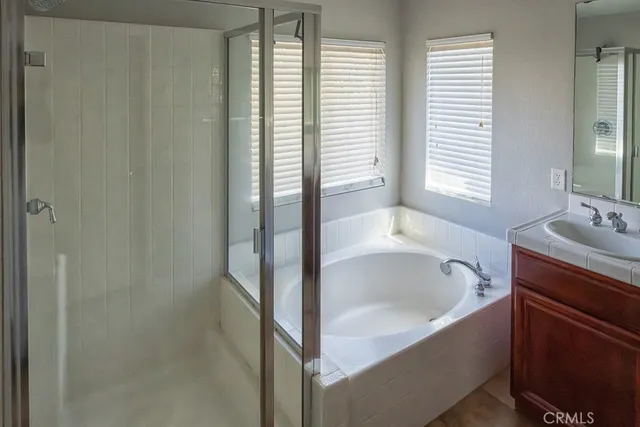 a bathroom with a tub sink and window