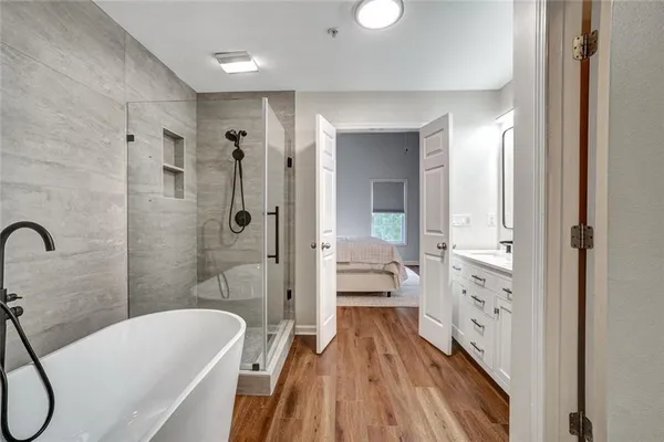 a spacious bathroom with a bathtub and a shower