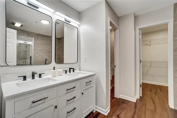 a bathroom with a double vanity sink mirror and double