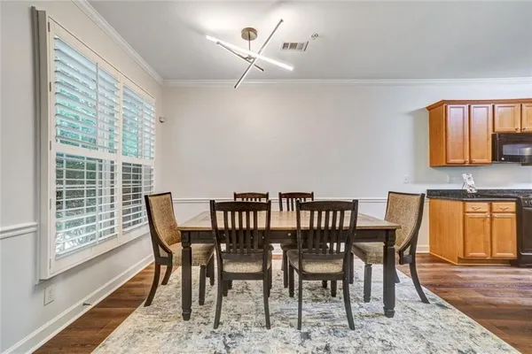 a view of a dining room with furniture and wooden floor