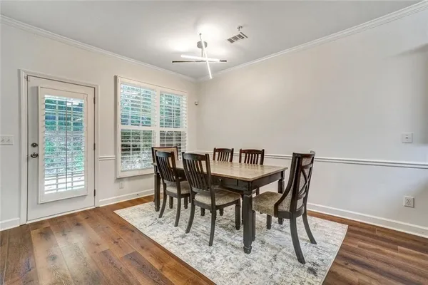 a view of a dining room with furniture and wooden floor