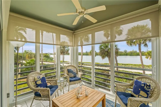 a living room with furniture and a floor to ceiling window