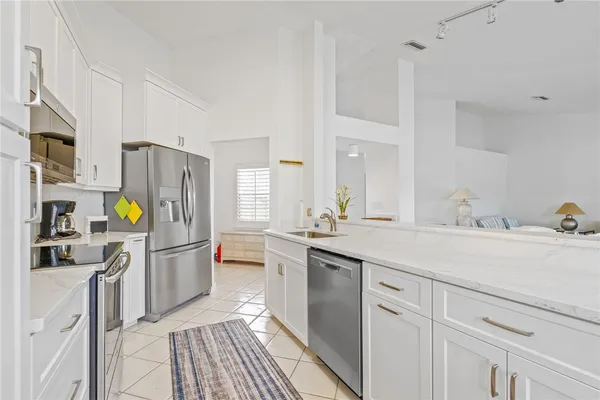 a kitchen with a sink appliances and cabinets