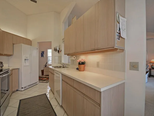 a utility room with cabinets washer and dryer