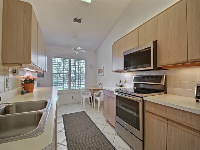 a kitchen with stainless steel appliances a stove sink microwave and cabinets