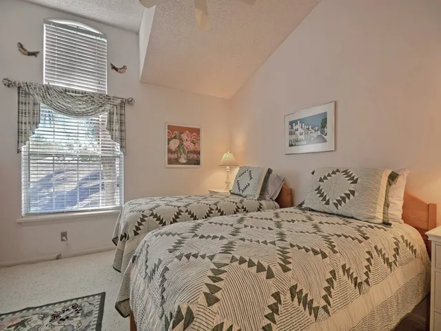 a bed sitting in a bedroom next to a window