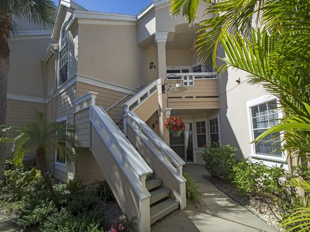 a view of a house with a yard and plants