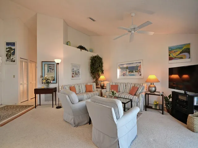 a living room with fireplace furniture and a flat screen tv