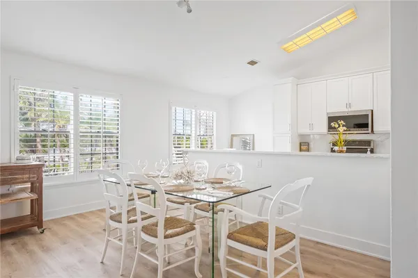 a view of a dining room with furniture and windows