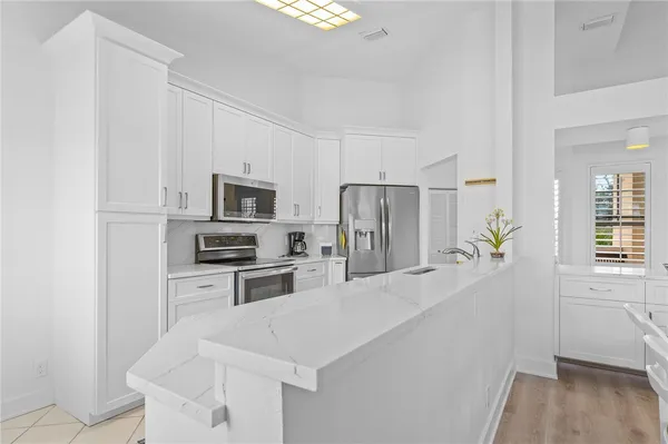 a kitchen with refrigerator cabinets and wooden floor