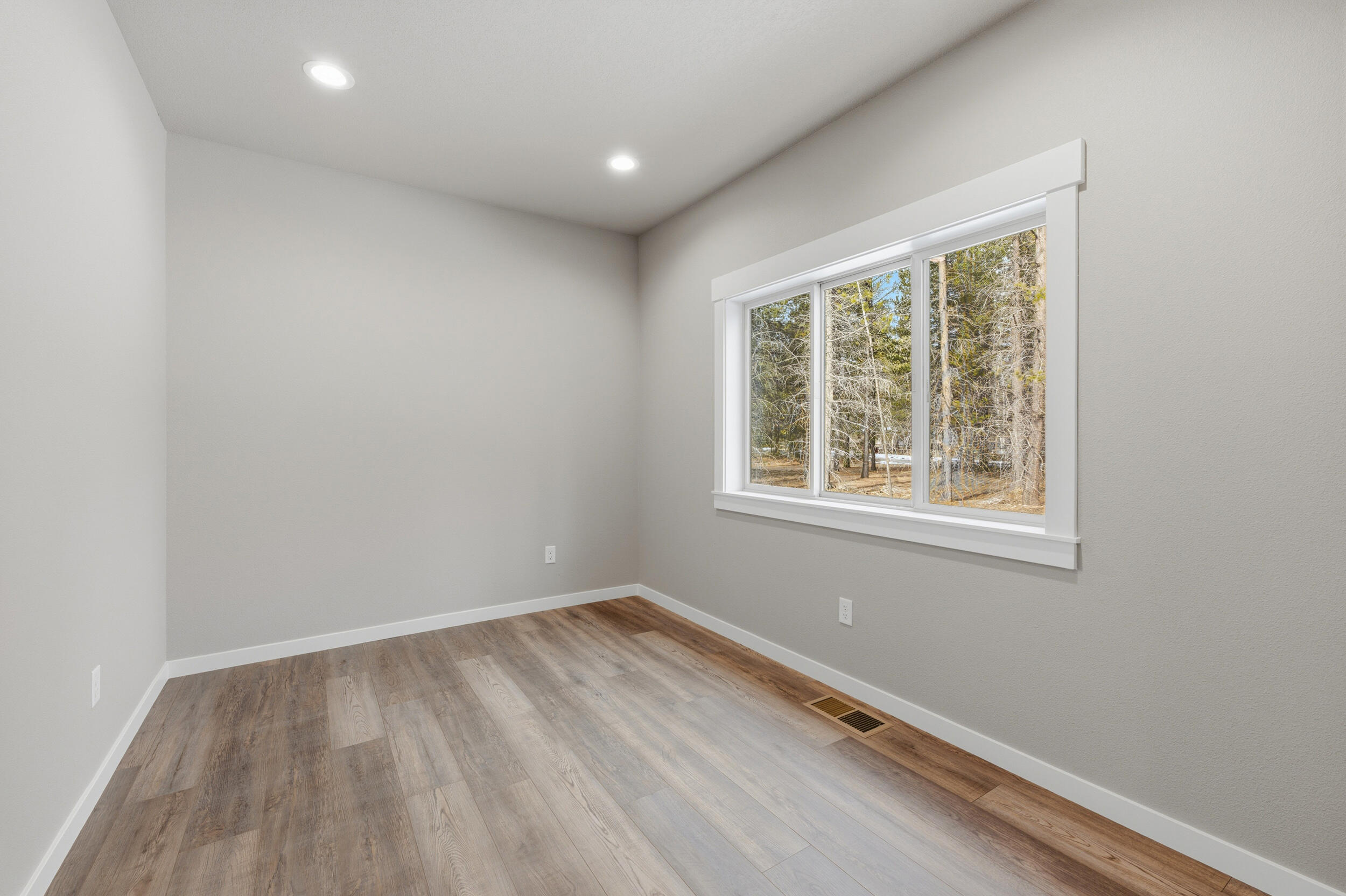 16083 Dyke Road, Unit 9 La Pine, OR 97739 - Photo 31 of 53 an empty room with wooden floor and windows