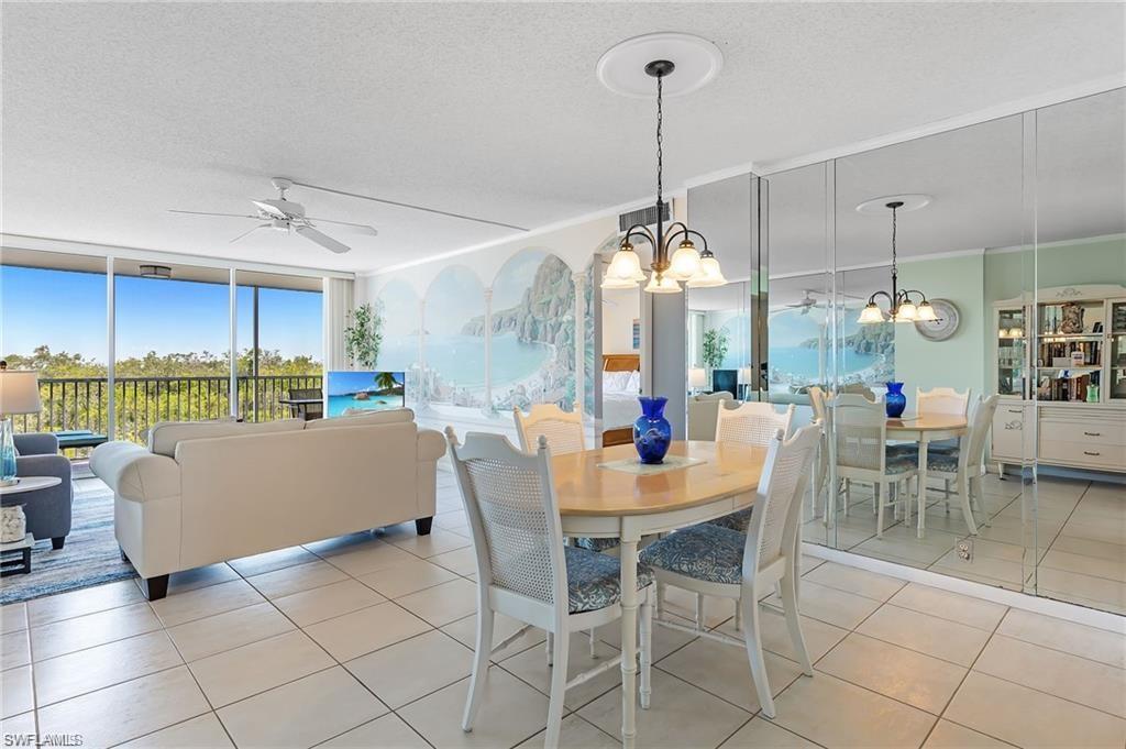 5 Bluebill Avenue, Unit 403 Naples, FL 34108 - Photo 12 of 41 a dining room view with a table and chairs