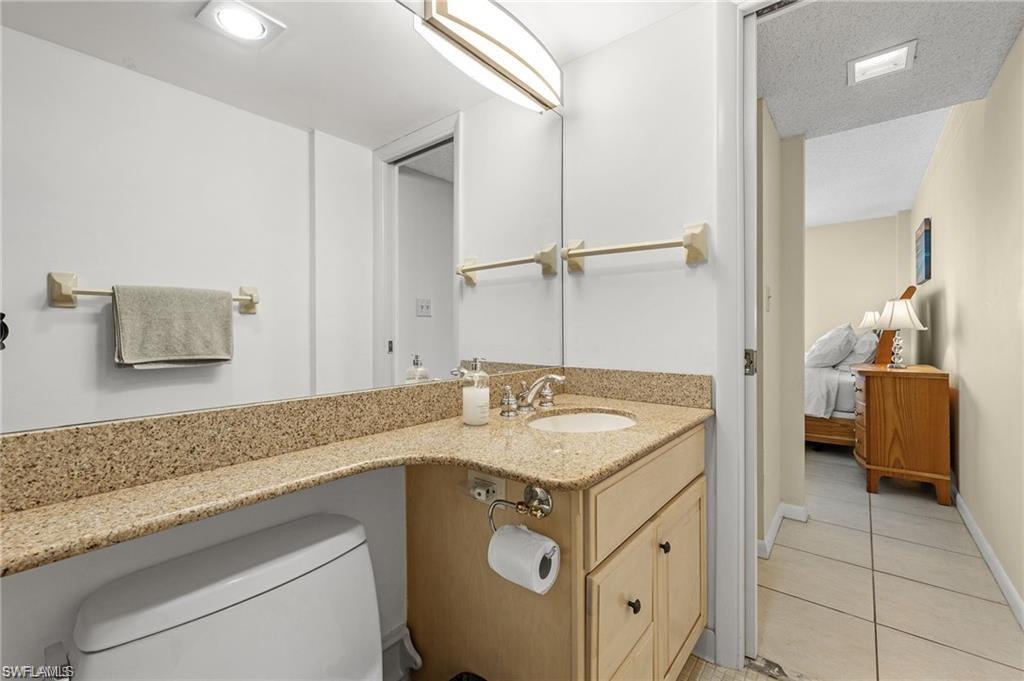 5 Bluebill Avenue, Unit 403 Naples, FL 34108 - Photo 18 of 41 a bathroom with a sink and a mirror