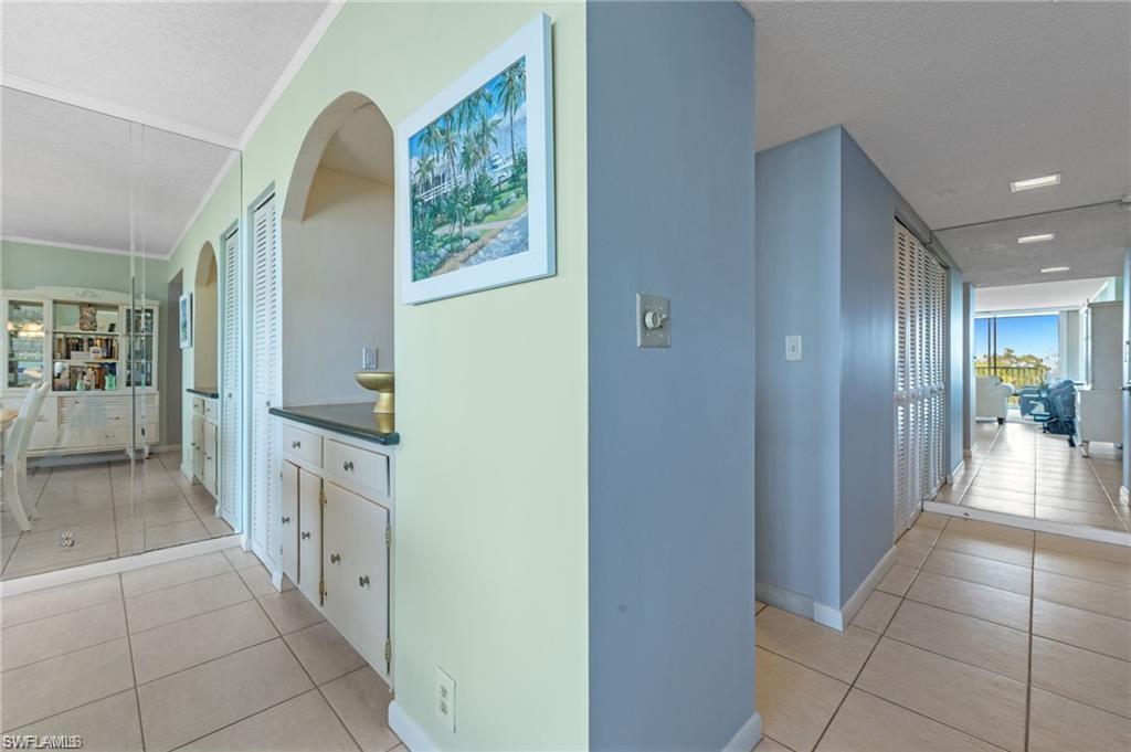 5 Bluebill Avenue, Unit 403 Naples, FL 34108 - Photo 21 of 41 a view of a hallway to an entryway with livingroom