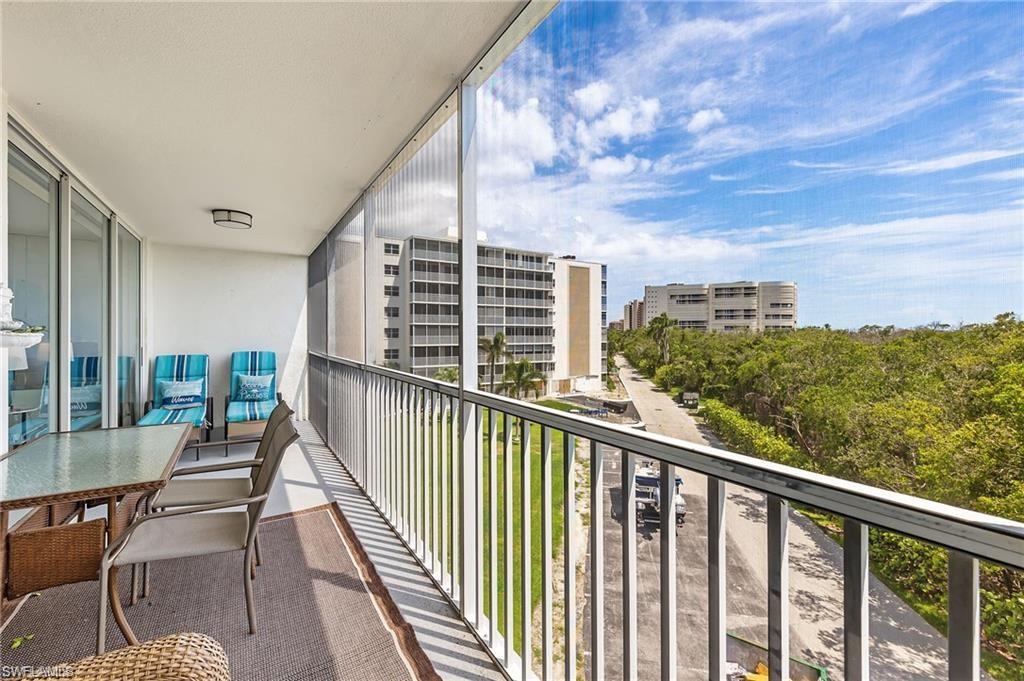 5 Bluebill Avenue, Unit 403 Naples, FL 34108 - Photo 25 of 41 a view of a balcony with two chairs and a table