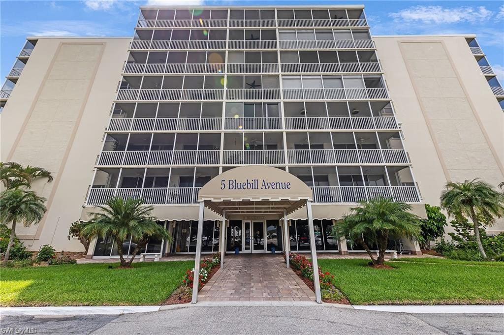 5 Bluebill Avenue, Unit 403 Naples, FL 34108 - Photo 32 of 41 a front view of a building with garden