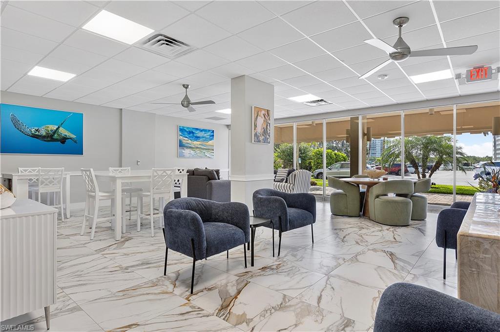 5 Bluebill Avenue, Unit 403 Naples, FL 34108 - Photo 35 of 41 a living room with furniture and a large window