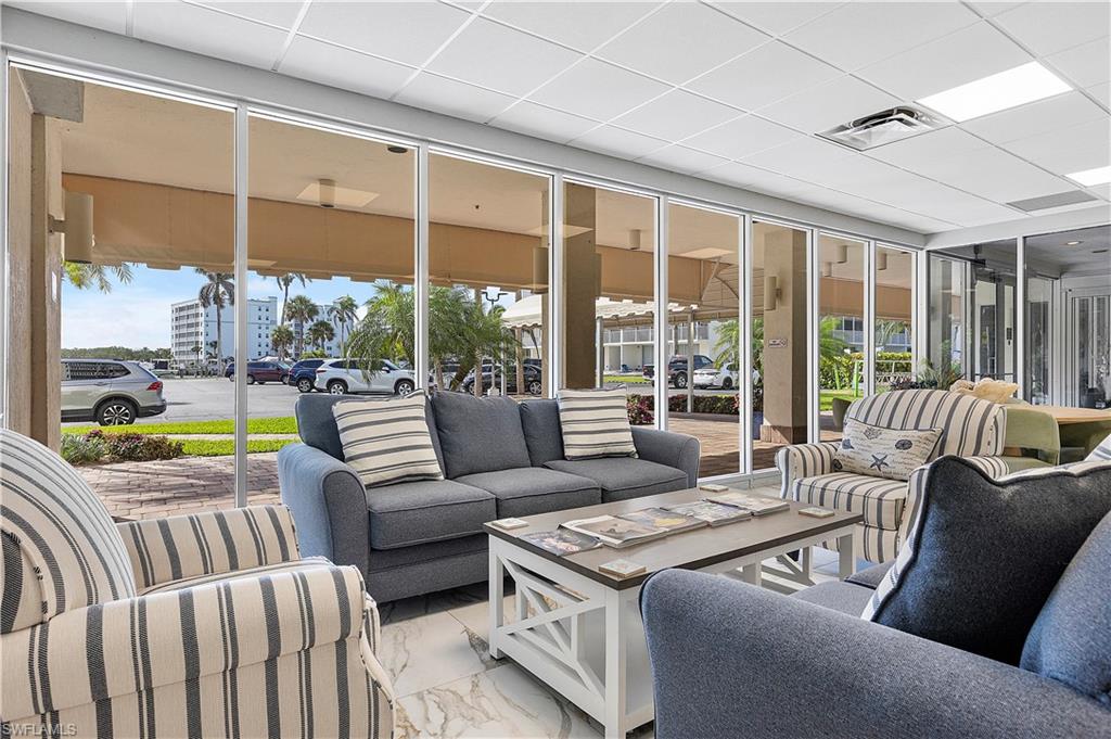 5 Bluebill Avenue, Unit 403 Naples, FL 34108 - Photo 36 of 41 a living room with furniture and a large window