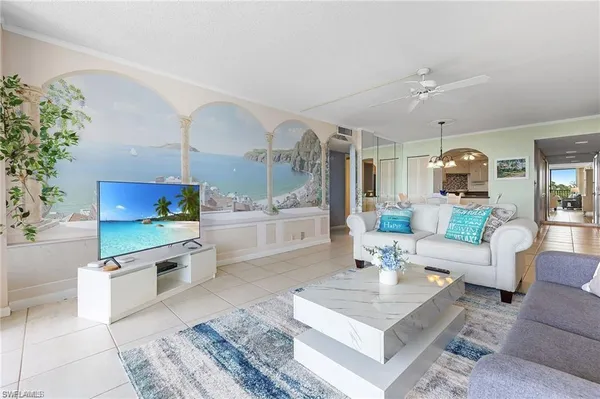 a living room with furniture a chandelier and a table