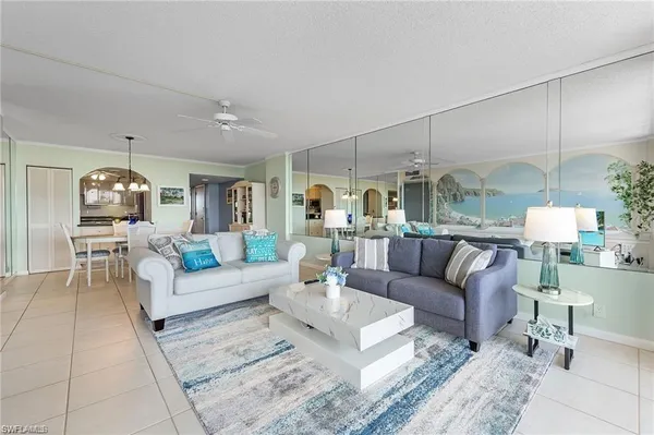 a living room with furniture and a chandelier