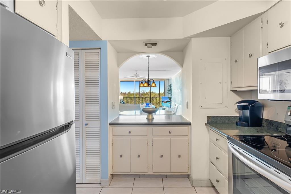 5 Bluebill Avenue, Unit 403 Naples, FL 34108 - Photo 8 of 41 a kitchen with a sink and cabinets