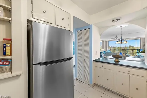 a kitchen with appliances a sink and cabinets