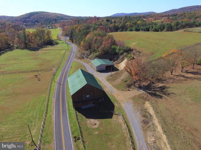 an aerial view of a house with a swimming pool