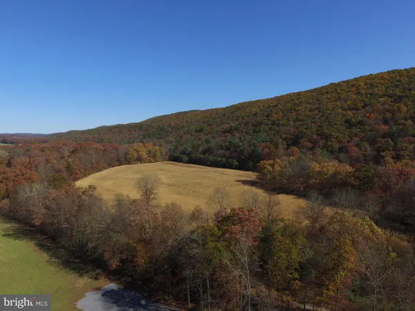 a view of a house with swimming pool and a yard