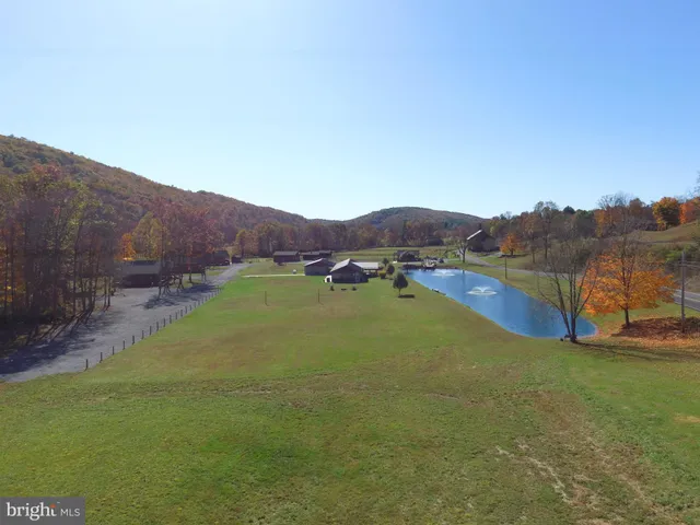 a view of a house with swimming pool and a yard