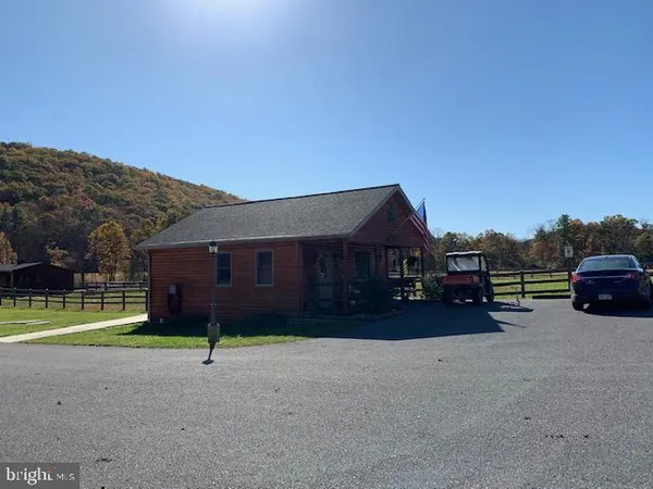 a kitchen with stainless steel appliances granite countertop a sink a stove a refrigerator cabinets a dining table and chairs