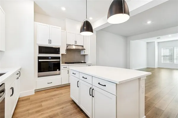 a kitchen with a stove a sink and a refrigerator