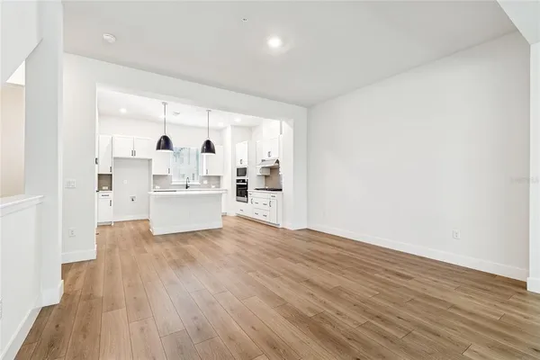 a view of a kitchen with wooden floor