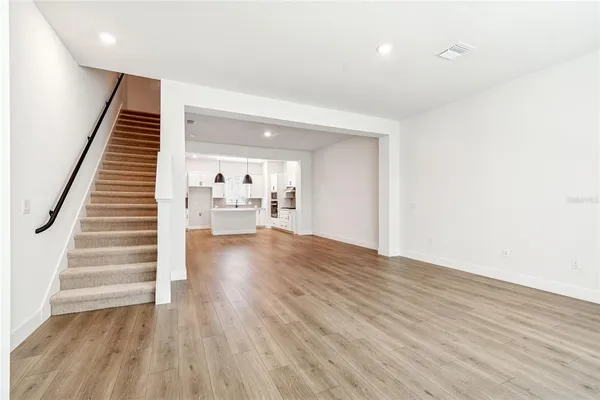 a view of a room with wooden floor and staircase