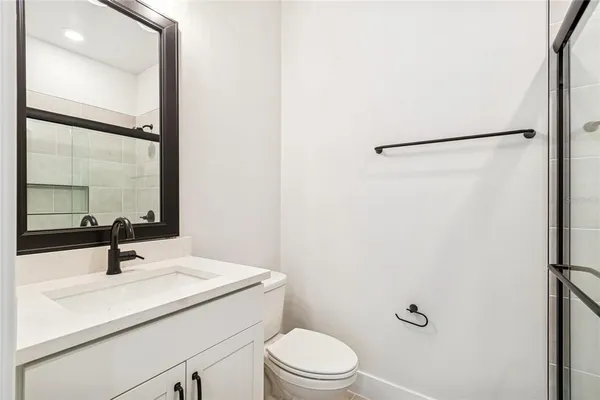 a bathroom with a sink toilet and mirror