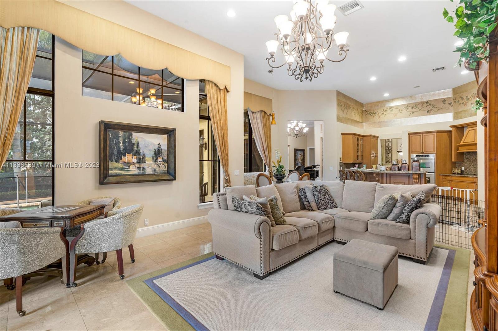 6911 Long Leaf Drive Parkland, FL 33076 - Photo 3 of 20 a living room with furniture a chandelier and a chandelier
