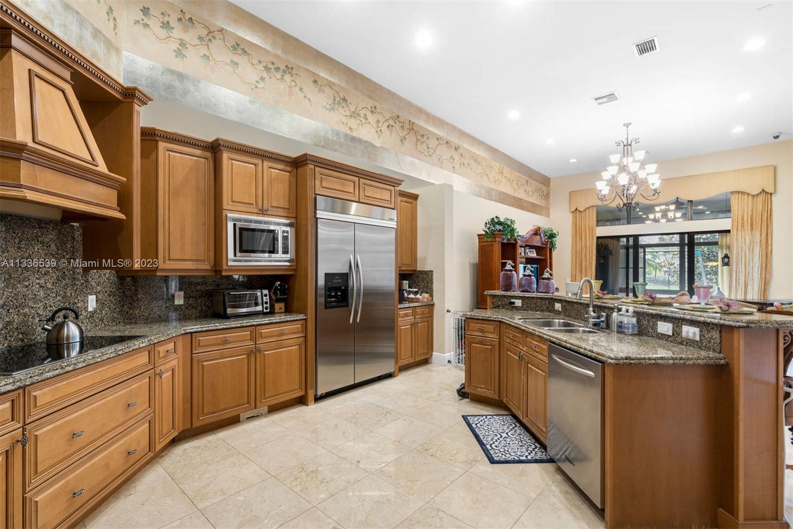 6911 Long Leaf Drive Parkland, FL 33076 - Photo 6 of 20 a large kitchen with stainless steel appliances lots of counter space and breakfast area