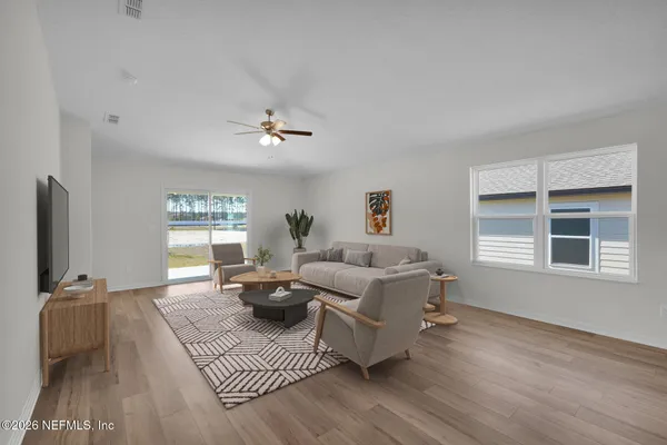 a living room with furniture or window and a wooden floor
