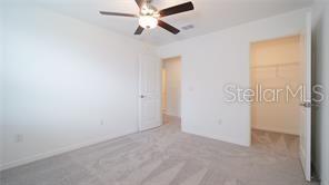 11142 Radiant Shr Loop San Antonio, FL 33576 - Photo 20 of 43 an empty room with closet and a chandelier fan