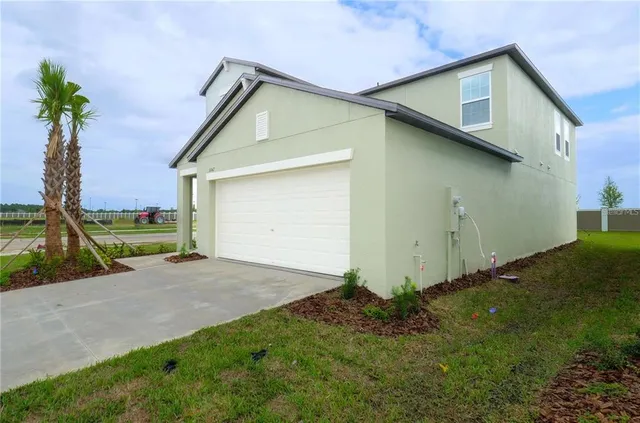 a view of a house with a yard and garage
