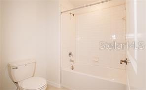 11142 Radiant Shr Loop San Antonio, FL 33576 - Photo 24 of 43 a white toilet sitting next to a bath tub