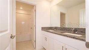 11142 Radiant Shr Loop San Antonio, FL 33576 - Photo 25 of 43 a bathroom with a granite countertop sink and a mirror